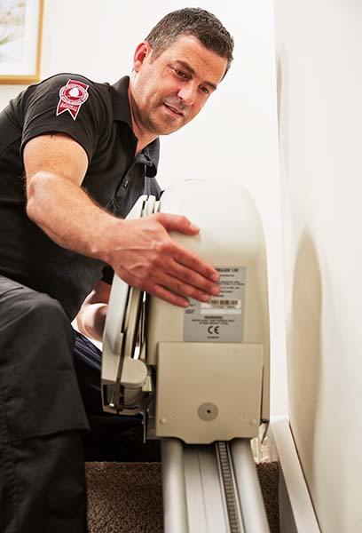 stairlift technician servicing stairlift in home